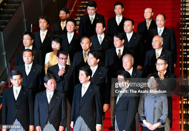 Prime Minister Shinzo Abe and his new cabinet members pose for photographs at the prime minister's official residence on August 3, 2017 in Tokyo,...