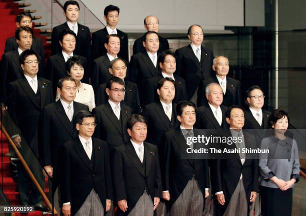 Prime Minister Shinzo Abe and his new cabinet members pose for photographs at the prime minister's official residence on August 3, 2017 in Tokyo,...