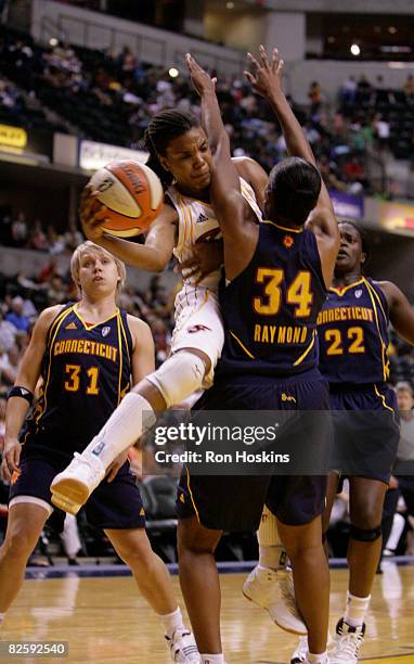 Tan White of the Indiana Fever battles Tamika Raymond of the Connecticut Sun at Conseco Fieldhouse on August 28, 2008 in Indianapolis, Indiana. NOTE...