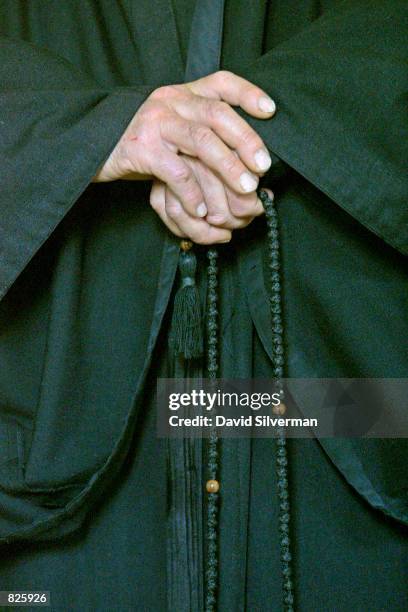 Greek-Melekite monk from the Catholic order of St. John in the Desert fingers his prayer beads as he worships in the order's chapel February 28, 2001...