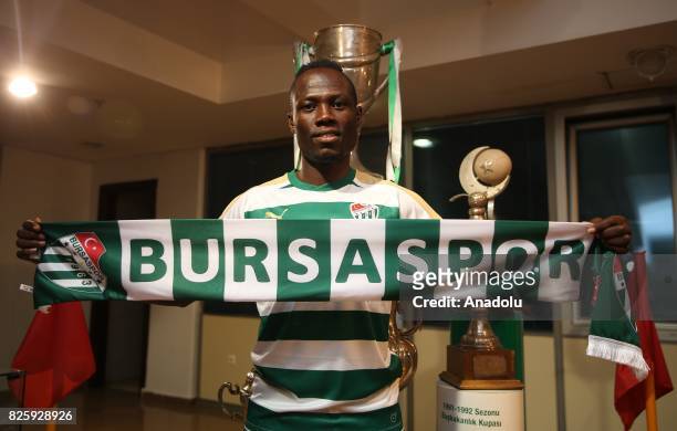 Bursaspor's new signing Ghanaian footballer Emmanuel Badu poses for a photo with Bursaspor scarf after signing a one-year contract in Bursa, Turkey...