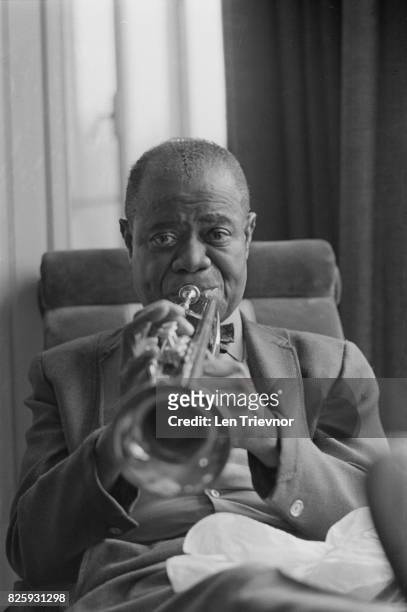 American jazz trumpeter and singer Louis Armstrong playing the trumpet, London, 27th October 1970.
