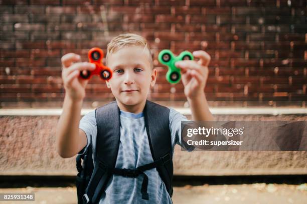 playing with spinner - fidget spinner stock pictures, royalty-free photos & images