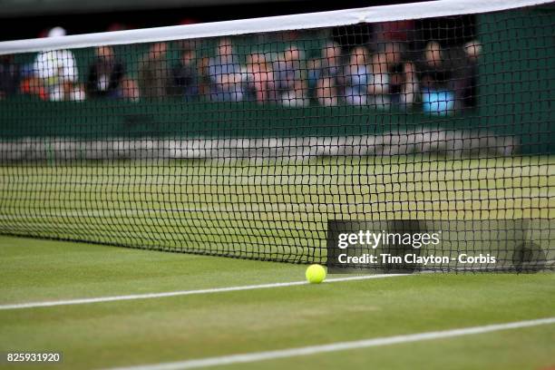 Tennis ball on the grass near the net on an outer court during the Wimbledon Lawn Tennis Championships at the All England Lawn Tennis and Croquet...