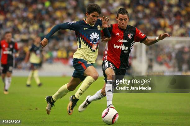 Carlos Orrantia of America fights for the ball with Cristian Calderon of Atlas during the 2nd round match between America and Atlas as part of the...