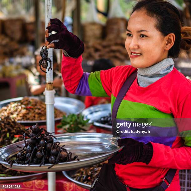 cambodian woman selling deep fried insects and tarantulas, cambodia - cambodia food stock pictures, royalty-free photos & images