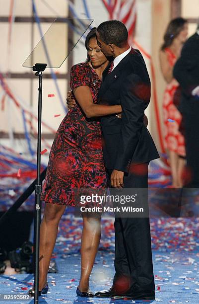 Democratic U.S. Presidential nominee Sen. Barack Obama hugs his wife Michelle Obama after his speech on day four of the Democratic National...