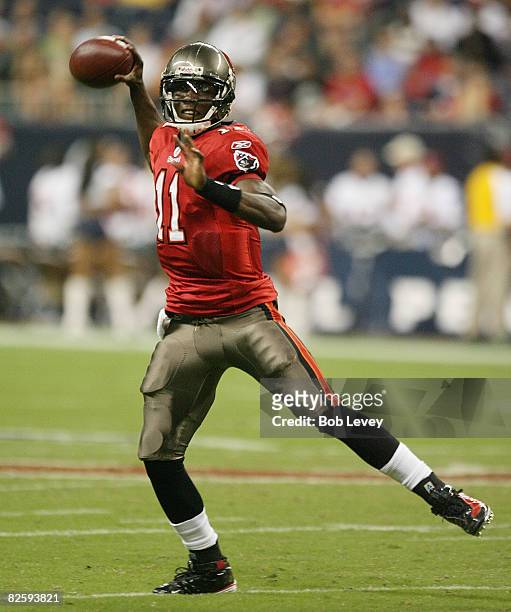 Quarterback Josh Johnson of the Tampa Bay Buccaneers rolls out looking down-field for a receiver against the Houston Texans at Reliant Stadium August...
