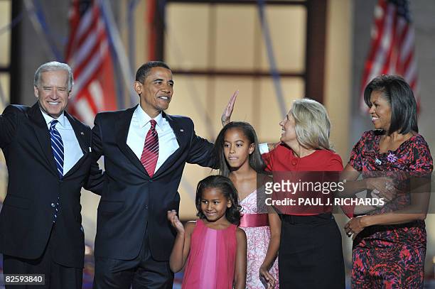 Democratic presidential nominee Barack Obama stands with his wife Michelle , vice presidential nominee Joe Biden and his wife Jill on stage with...