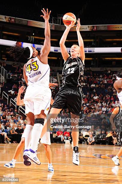 Ann Wauters of the San Antonio Silver Stars shoots against Le'coe Willingham of the Phoenix Mercury on August 28 at U.S. Airways Center in Phoenix,...