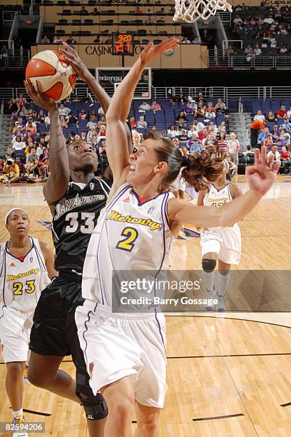 Sophia Young of the San Antonio Silver Stars shoots against Kelly Miller of the Phoenix Mercury on August 28 at U.S. Airways Center in Phoenix,...