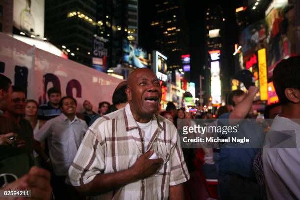 Pierre Mazarin, of New York City, tears up after watching in Time Square a projection of U.S. Sen. Barack Obama accepting the Democratic presidential...