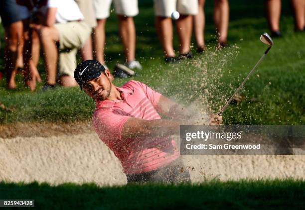 Jason Day of Australia plays a shot out of a bunker on the tenth hole during the first round of the World Golf Championships - Bridgestone...
