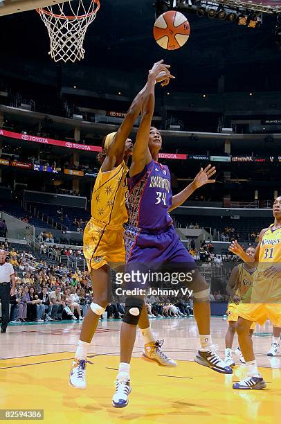 Adrian Williams-Strong of the Sacramento Monarchs goes up for a shot against Lisa Leslie of the Los Angeles Sparks during their game on August 28,...