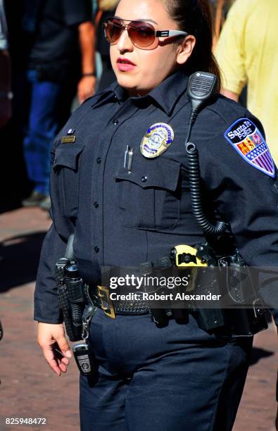 Santa Fe, New Mexico, police officer walks through the historic Plaza in Santa Fe, New Mexico, during a festival in the capital city.