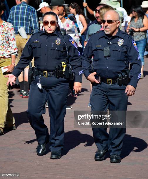 Santa Fe, New Mexico, police officers walk through the historic Plaza in Santa Fe, New Mexico, during a festival in the capital city.