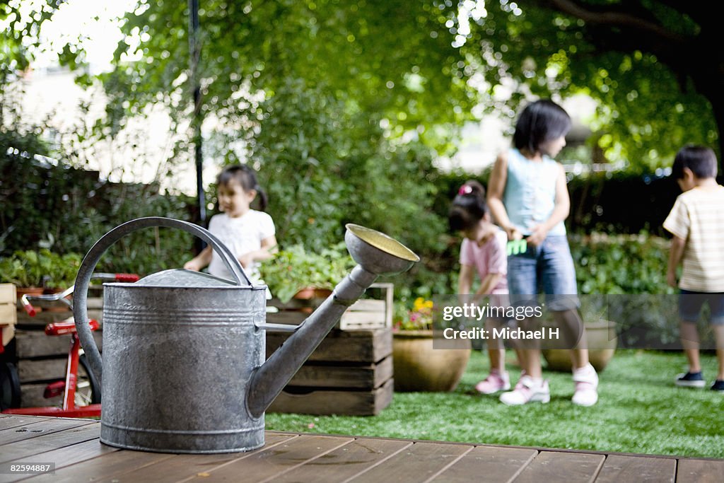 Watering pot in garden where children are playing