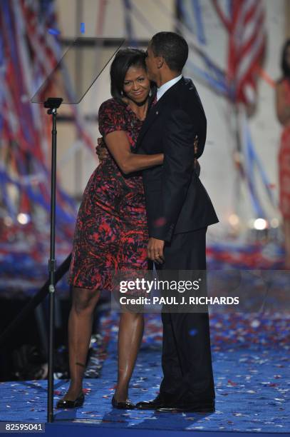 Democratic presidential nominee Barack Obama kisses his wife Michelle on stage at the end of the Democratic National Convention 2008 at the Invesco...