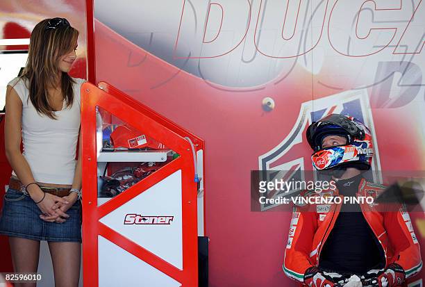 Australian world champion Casey Stoner of Ducati Marlboro team looks at his wife Adriana during a pause during the free practice session ahead of...
