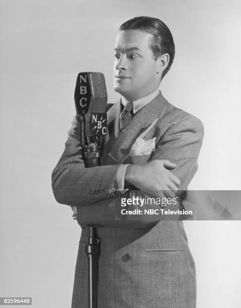British-born actor and comedian Bob Hope at an NBC radio mike during his time as compere of the Pepsodent Show, 21st November 1938.
