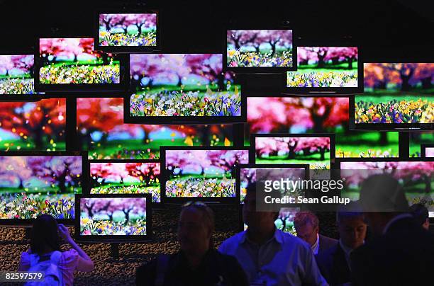 Visitors look at flat panel LCD televisions at the Panasonic Viera stand at the IFA consumer electronics trade fair on August 29, 2008 in Berlin,...