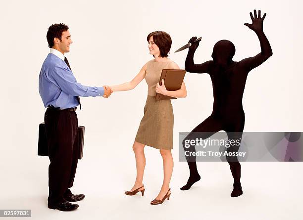 business pe shaking hands with backstabber. - stabbed in the back stock pictures, royalty-free photos & images