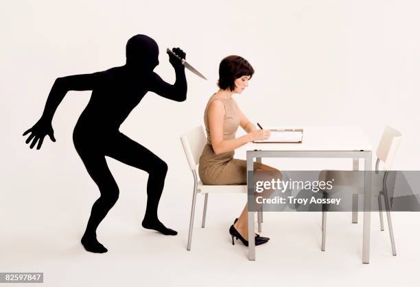 business woman being attacked by adversary - stabbed in the back stock pictures, royalty-free photos & images