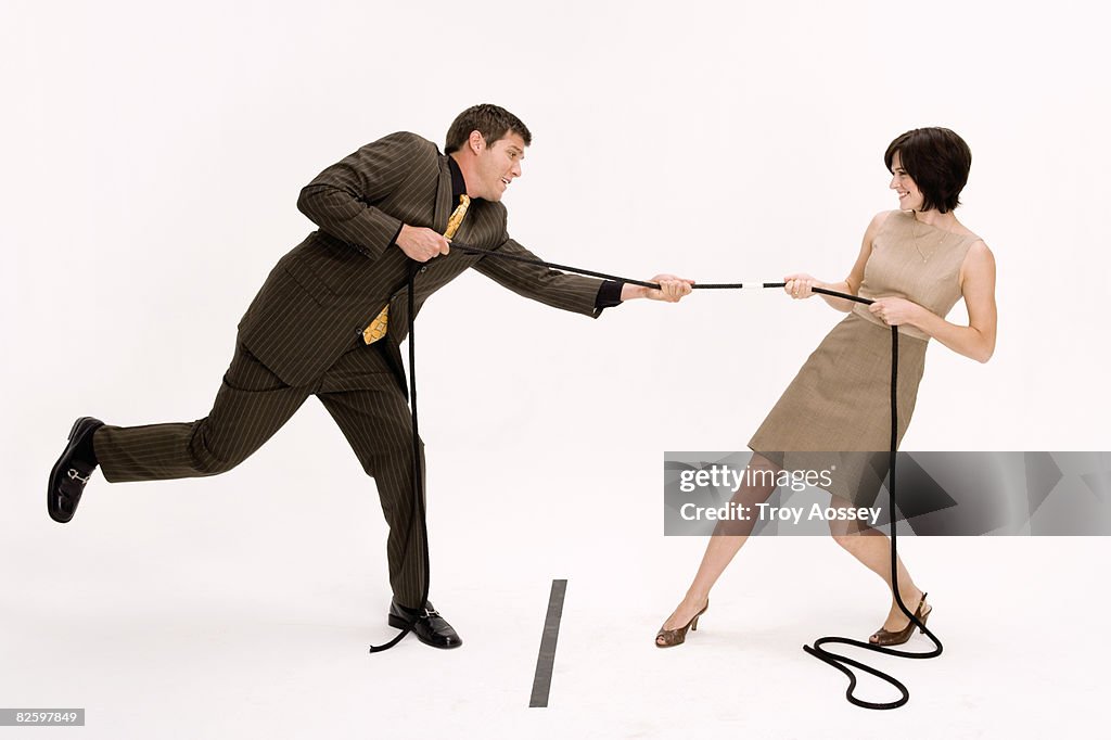 Man and woman playing tug of war