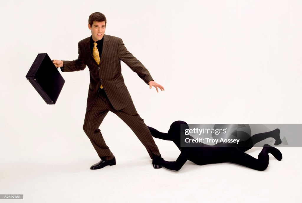 Business man being held back by