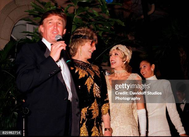 Married American couple, real estate developer Donald Trump and actress Marla Maples , stand with former competative swimmer Marjorie Post Dye on...