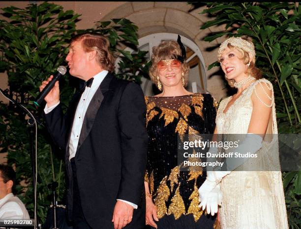 Married American couple, real estate developer Donald Trump and actress Marla Maples , stand with former competative swimmer Marjorie Post Dye on...