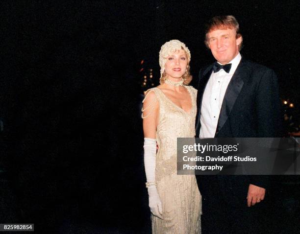 Portrait of married American couple, actress Marla Maples and real estate developer Donald Trump, as they pose together during a 'roaring 20's' party...