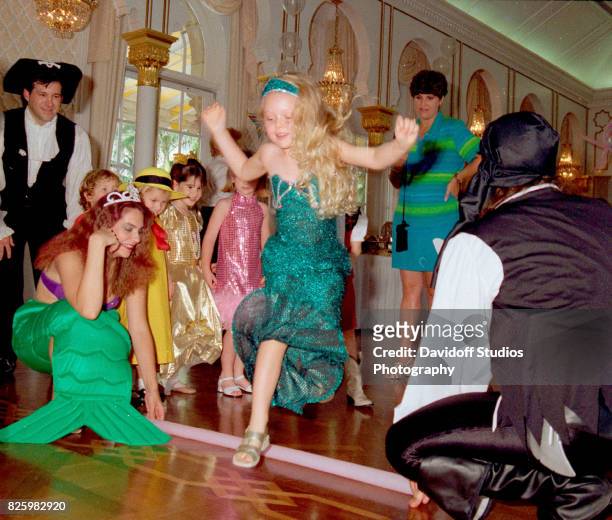 With the help of unidentified actors , Tiffany Trump and guests play a limbo game during her fifth birthday party at the Mar-a-Lago estate, Palm...