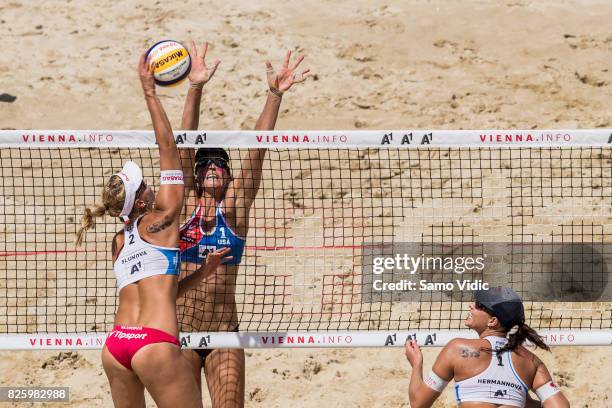 Marketa Slukova of Czech Republic spikes the ball over Lauren Fendrick of the United States at FIVB Beach Volleyball World Championships on August 3,...