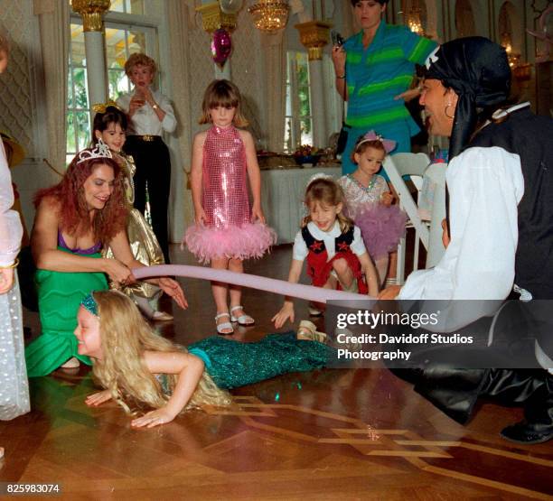 With the help of unidentified actors , Tiffany Trump and guests play a limbo game during her fifth birthday party at the Mar-a-Lago estate, Palm...