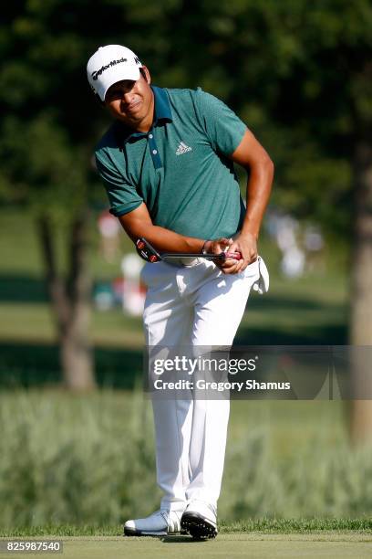 Andres Romero of Argentina putts on the fifth green during thei first round of the World Golf Championships - Bridgestone Invitational at Firestone...