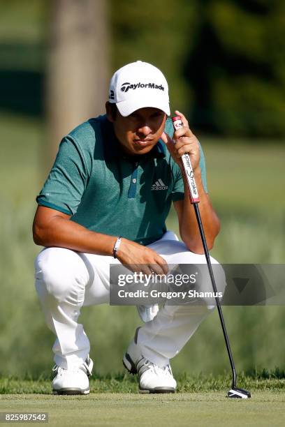 Andres Romero of Argentina putts on the fifth green during thei first round of the World Golf Championships - Bridgestone Invitational at Firestone...