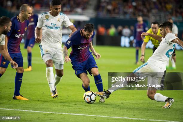 Lionel Messi of Barcelona weaves through Marco Asensio of Real Madrid and Casemiro of Real Madrid during the International Champions Cup El Clásico...