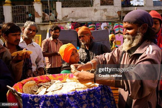 muslim men organize common charity activities on the streets of local mosques - ramadan 2017 india stock pictures, royalty-free photos & images