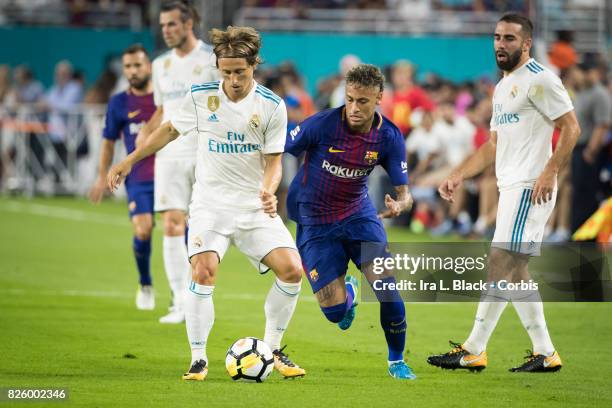 Neymar of Barcelona fights for control of the ball against Luka Modric of Real Madrid during warm ups during the International Champions Cup El...