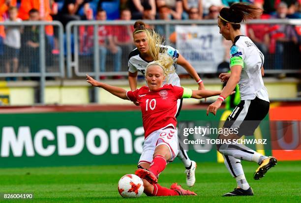 Denmark's forward Pernille Harder vies for the ball with Austria's defender Sophie Maierhofer and Austria's defender Viktoria Schnaderbeck during the...