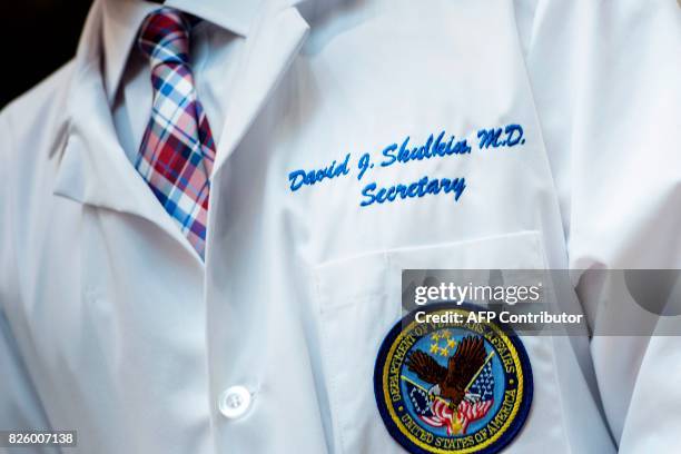 Secretary of Veterans Affairs David J. Shulkin listens while US President Donald Trump speaks about new technology used by the Department of Veterans...