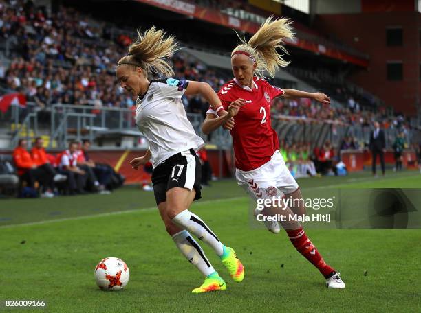 Sarah Puntigam of Austria is tackled by Line Roddik of Denmark during the UEFA Women's Euro 2017 Semi Final match between Denmark and Austria at Rat...