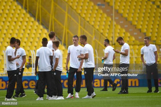 Sturm Graz' players arrive on the pitch before their UEFA Europa League third qualifying round second match against Fenerbahce on August 3, 2017 at...