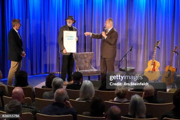 Songwriter Jack Tempchin is presented an award by city councilman Tom LaBonge at the Grammy Museum in Los Angeles, California on November 21, 2014.