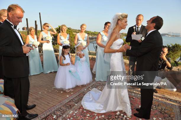 Singer Paul Anka and Anna Anka hold hands during their wedding at Hotel Cala di Volpe on July 26, 2008 in Porto Cervo, Sardinia, Italy.
