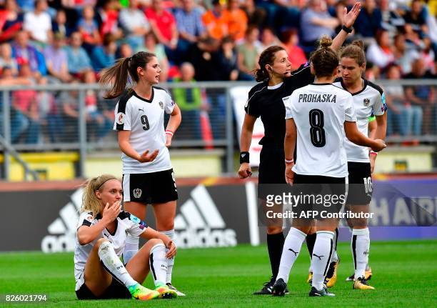 Austria's midfielder Sarah Puntigam reacts after a collision during the UEFA Womens Euro 2017 football tournament semi-final match between Denmark...