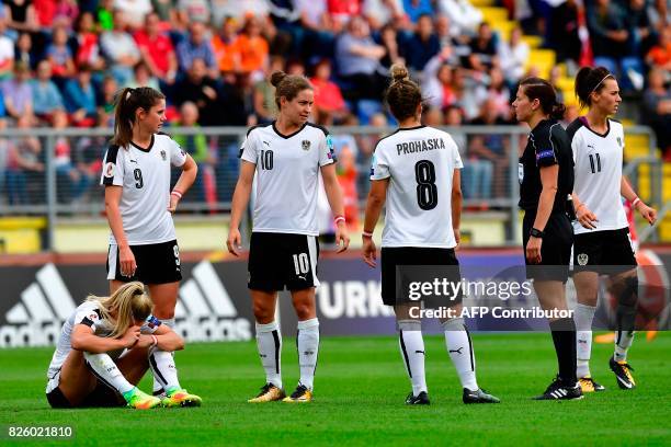 Austria's midfielder Sarah Puntigam reacts after a collision during the UEFA Womens Euro 2017 football tournament semi-final match between Denmark...