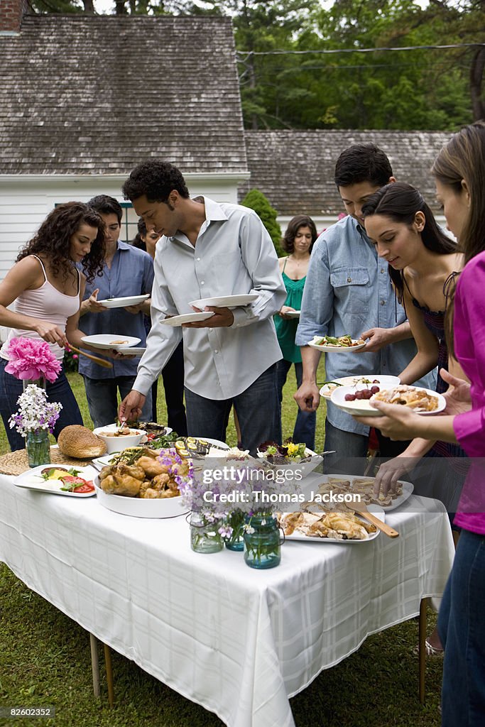  Hispanics at outdoor garden party at country home