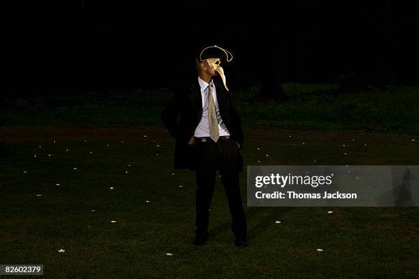 carneval mask party outdoors at night - wearing mask side view stock pictures, royalty-free photos & images